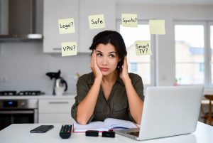 Person researching IPTV for the first time with common questions about legality, VPNs, sports streaming and Smart TV compatibility.