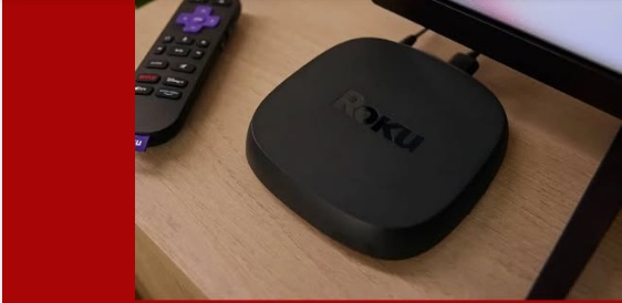 Roku streaming device with remote next to a TV screen, illustrating IPTV setup on Roku